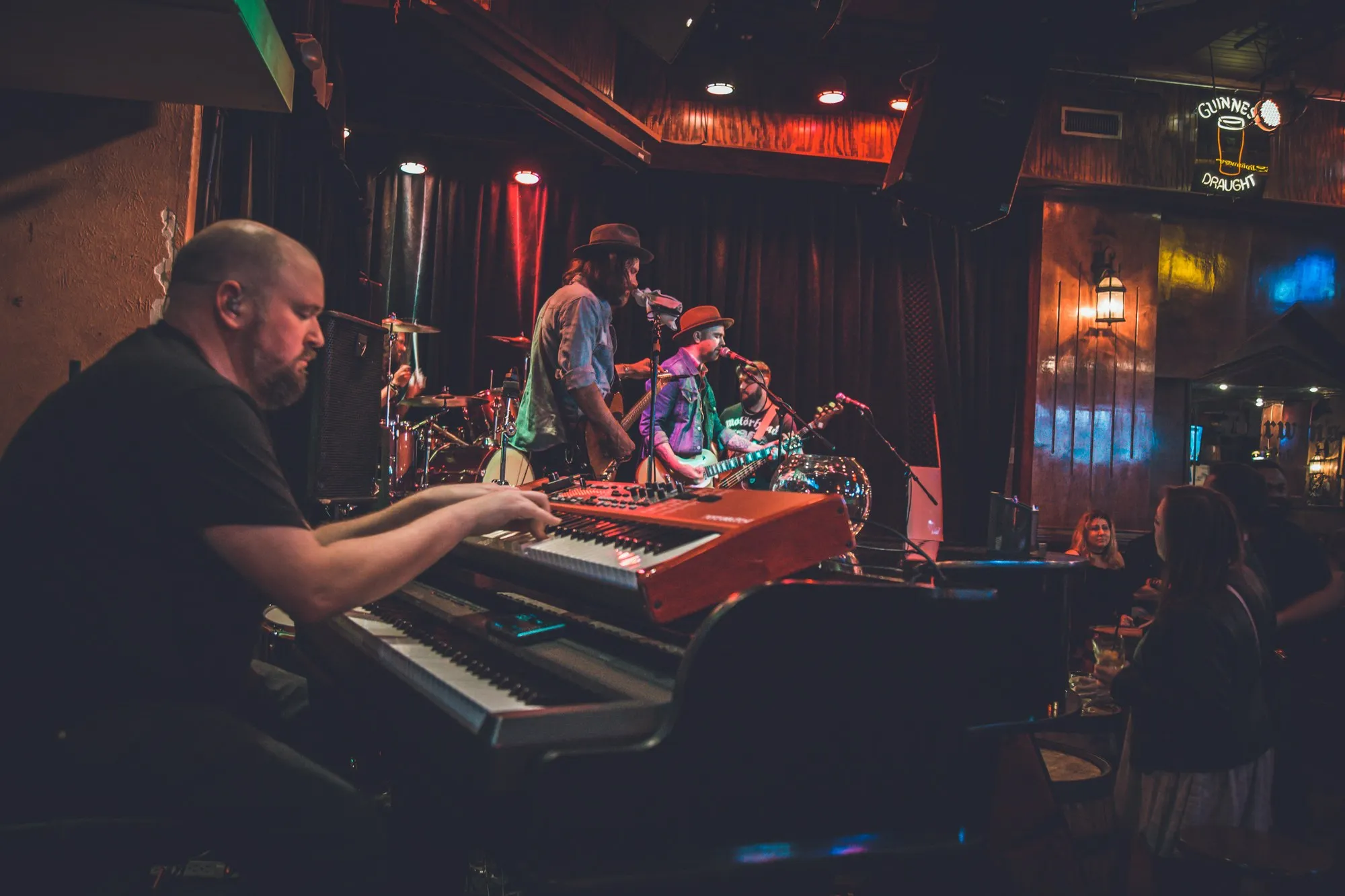 Playing keys at the front of a stage while the rest of the band performs behind.